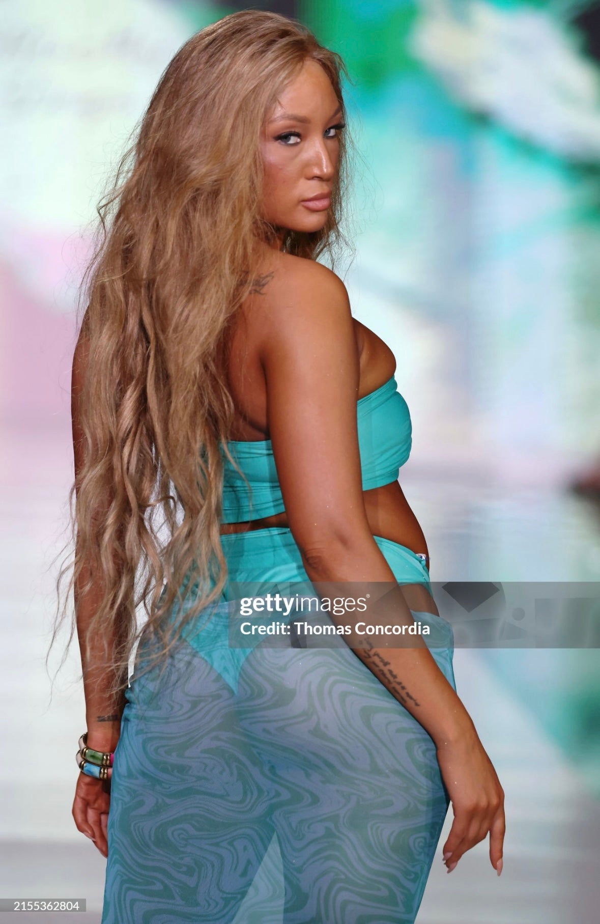 Turquoise bandea bikini with full brief bottoms and sheer patterned skirt
