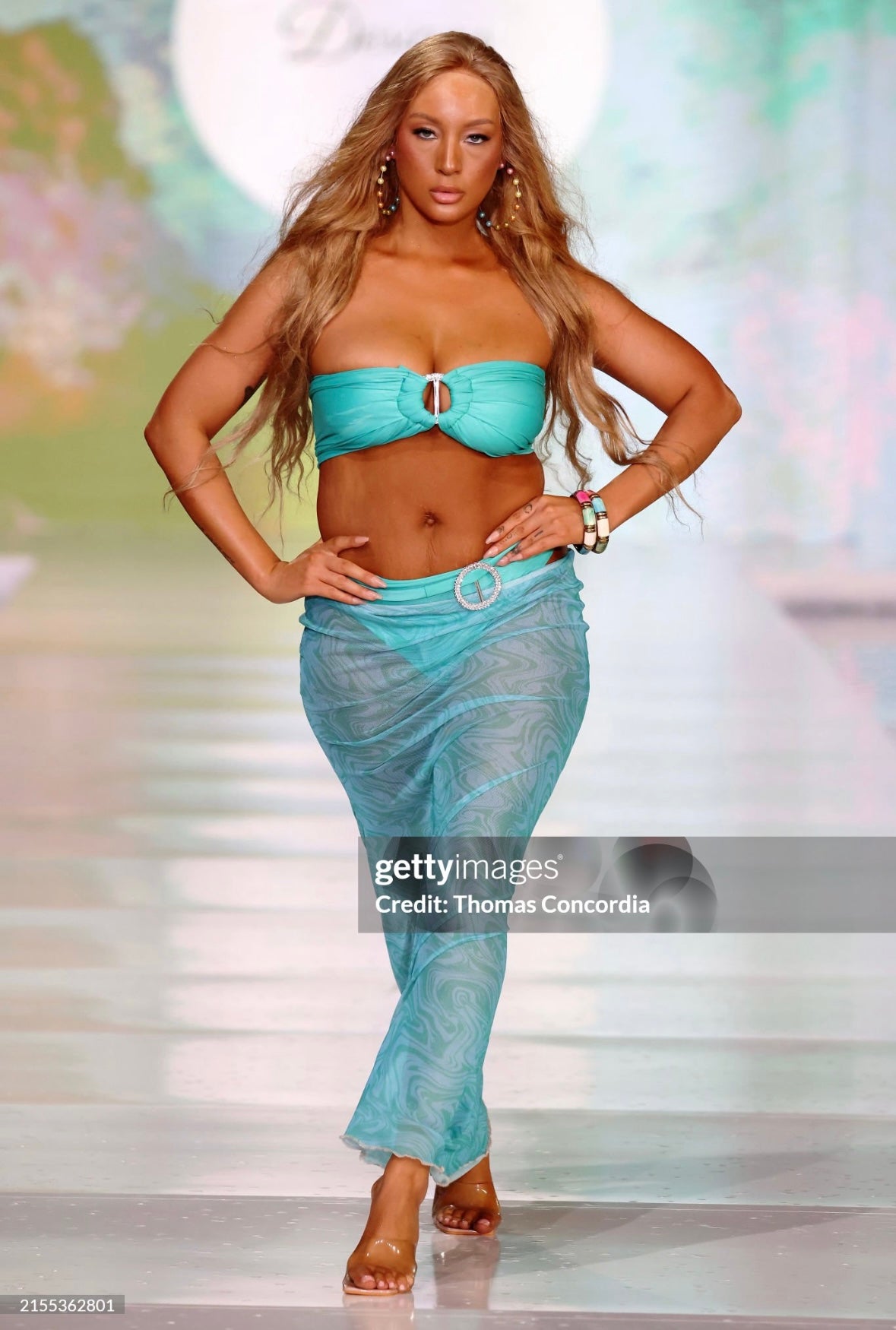 Turquoise bandea bikini with full brief bottoms and sheer patterned skirt